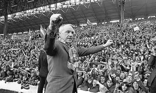 Bill Shankly at Anfield with his hands held up in celebration.