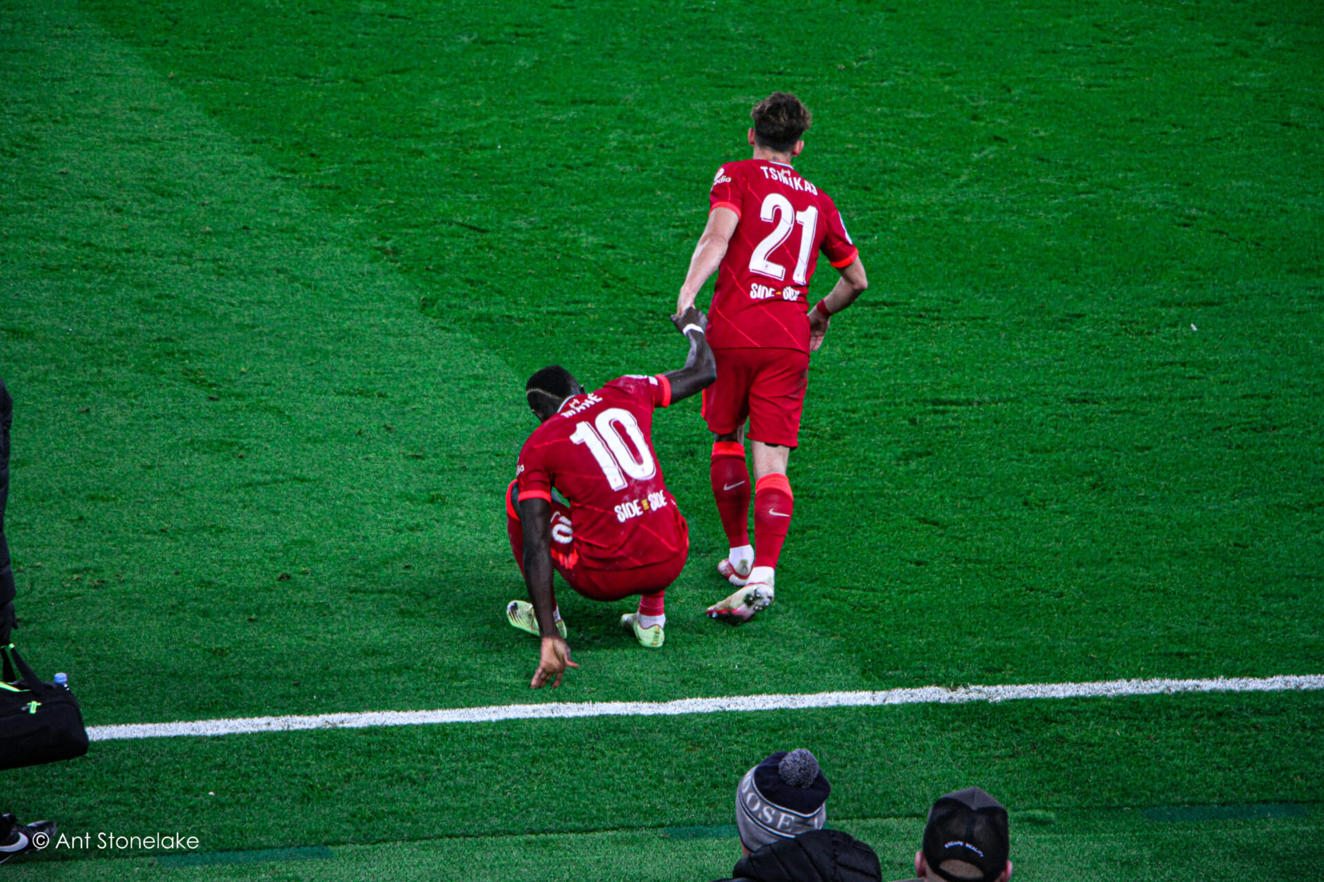 Kostas Tsimikas helping Sadio Mane get up after a challenge against Atletico Madrid. 
