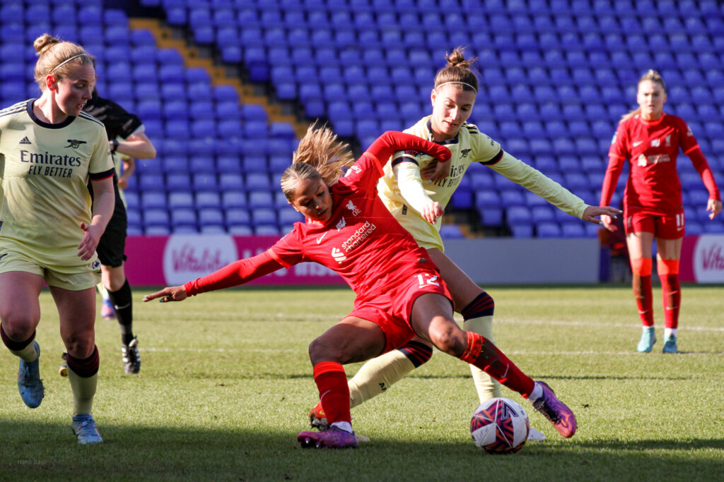 Steph Catley tries to steal the ball from Taylor Hinds