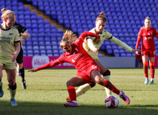 Steph Catley tries to steal the ball from Taylor Hinds