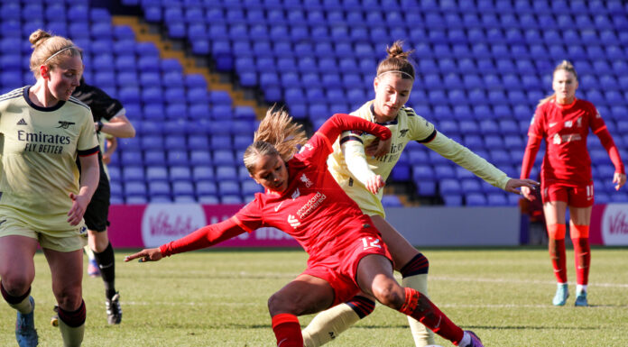 Steph Catley tries to steal the ball from Taylor Hinds