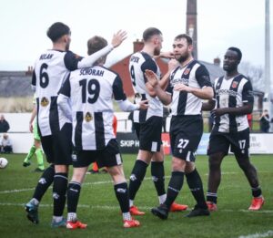 Callum Schorah is part of the celebrations as Chorley go 1-0 up against Leek Town. 