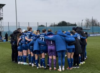 Brian Sorensen's Everton women huddled after Chelsea defeat.