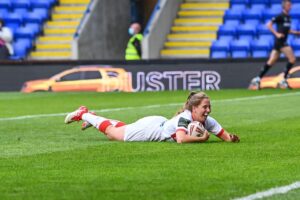 Tara Jones goes over for a try. Photo license to Alamy.
