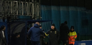 Brian Sorensen shakes hands with the Manchester United bench after a 2-0 loss. Pic by Matty McClennon.