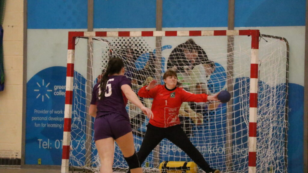 Handball goalkeeper makes fast break save 