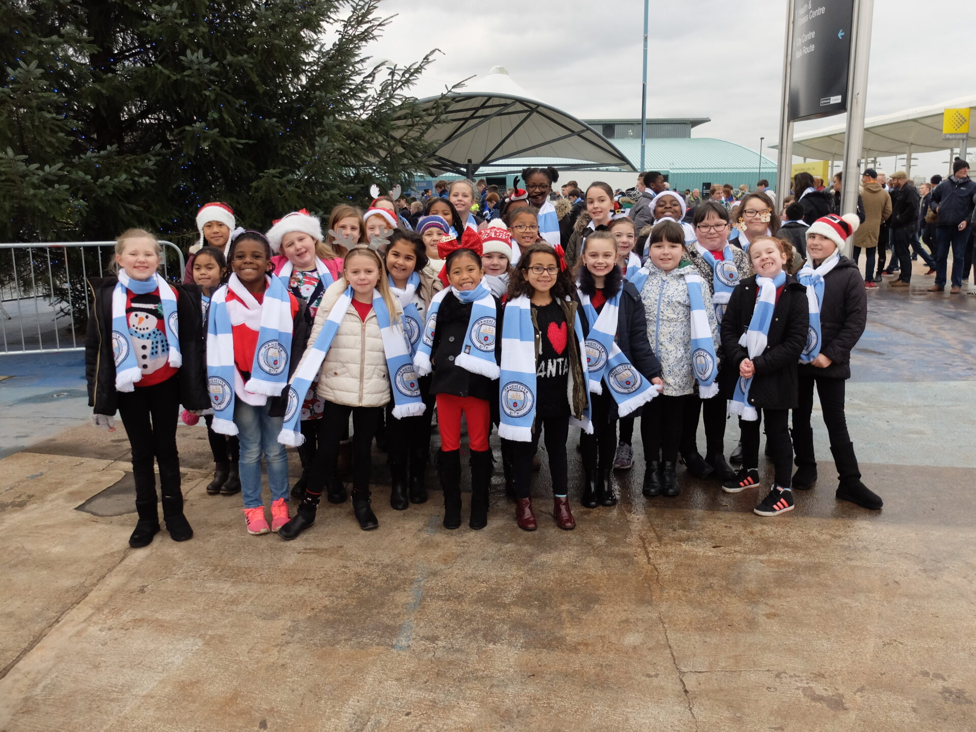 A group of Manchester City fans outside the Etihad Stadium