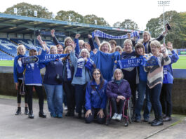 A group of female Bury FC fans inside Gigg Lane including Zoe Hitchen