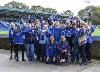 A group of female Bury FC fans inside Gigg Lane including Zoe Hitchen