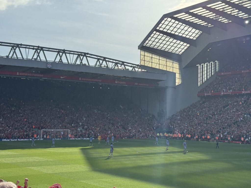 Liverpool players celebrate in front of the Kop by Daniel Moffat