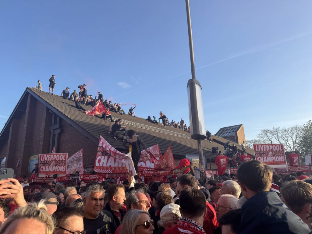 Liverpool sat on rooftops celebrating the Premier League by Daniel Moffat
