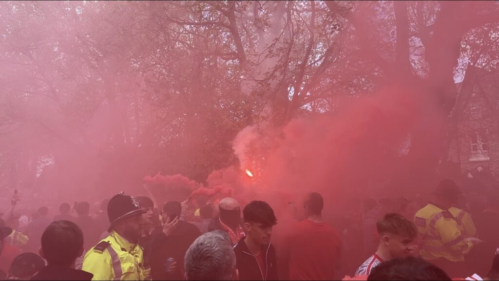 Liverpool fan holding a flare by Daniel Moffat