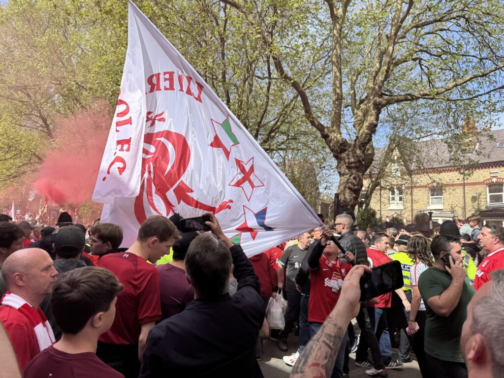 Liverpool flags heading towards the Kop by Daniel Moffat