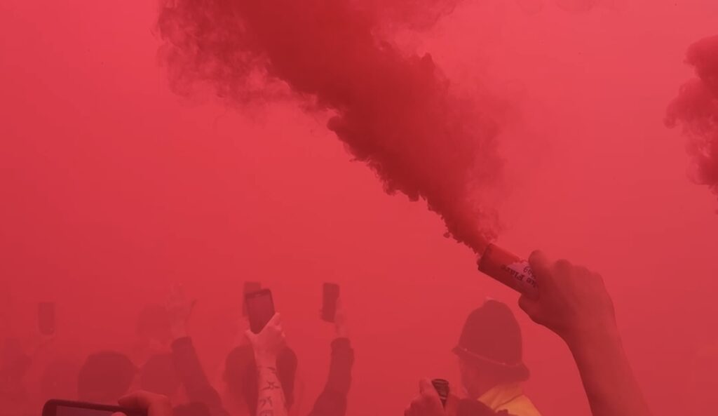 Liverpool red flares covering the sky by Daniel Moffat