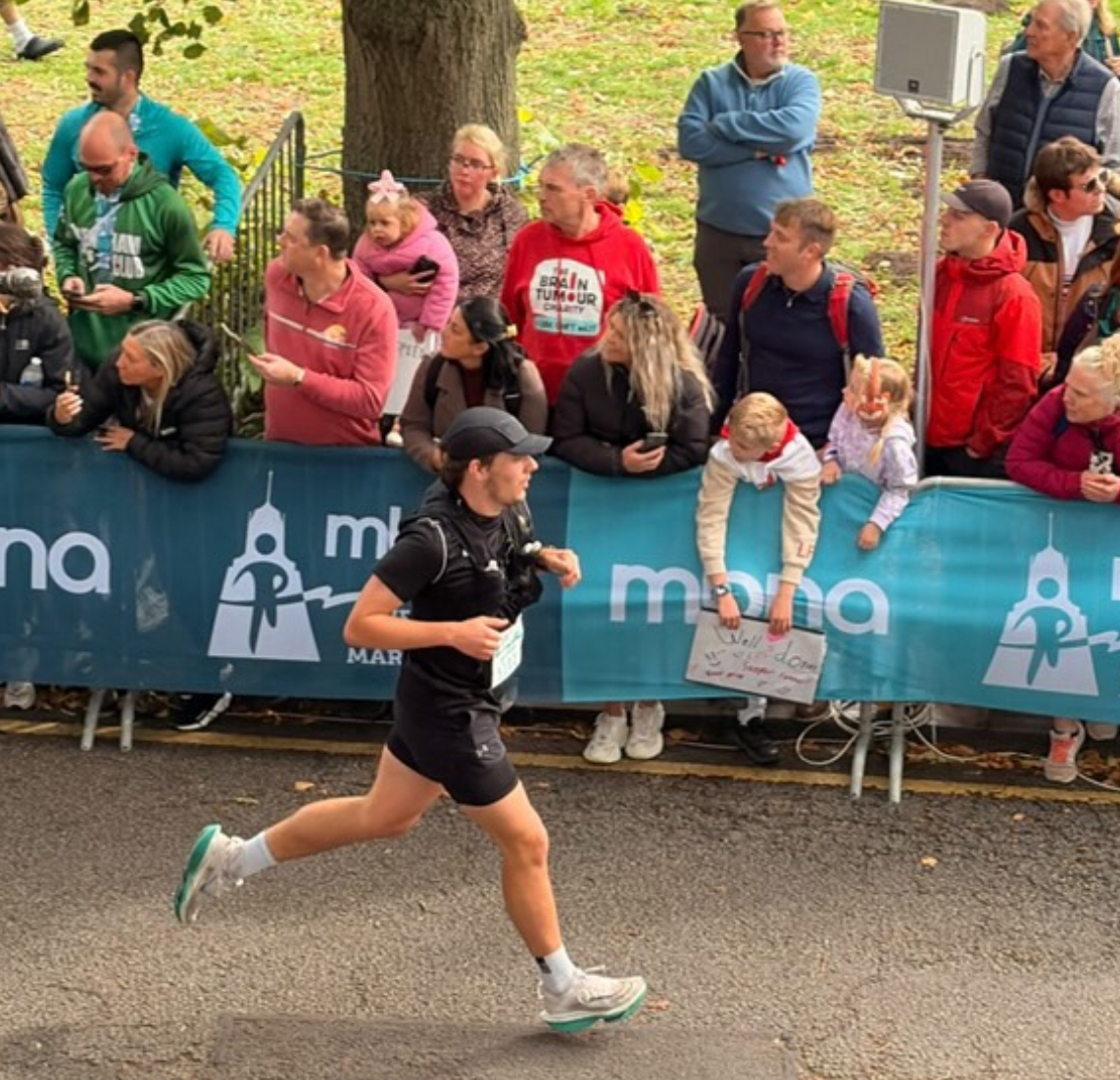 Matthew Dob running through the Chester Marathon while being cheered on. Photo by Benjamin Rimmer
