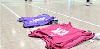 Bibs lined up on a netball court. Image taken by Sienna Hughes.