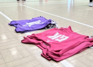 Elite netball’s growing grip on Merseyside Bibs lined up on a netball court. Image taken by Sienna Hughes.