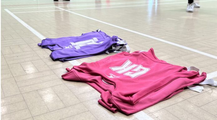 Elite netball’s growing grip on Merseyside Bibs lined up on a netball court. Image taken by Sienna Hughes.