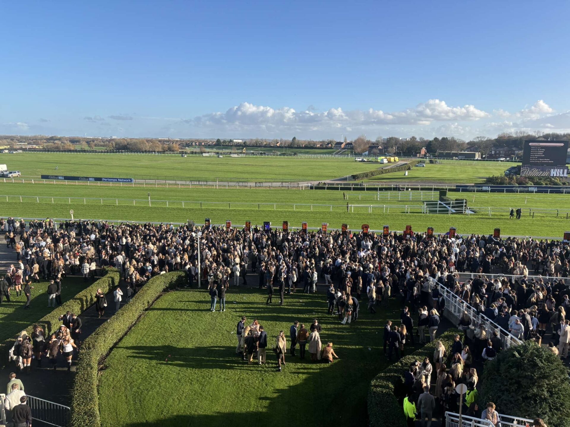 Aintree racegoers watch on during first meeting on the new season. Photo by Alex Roberts.