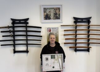 Ju Jitsu Legend Sue King receives her 8th degree Black Belt. Sue King holding certificate