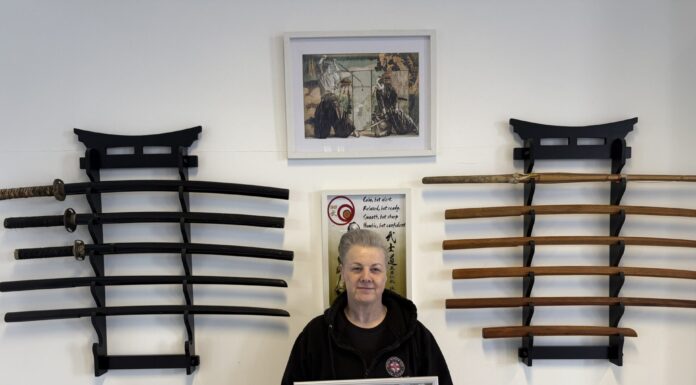 Ju Jitsu Legend Sue King receives her 8th degree Black Belt. Sue King holding certificate